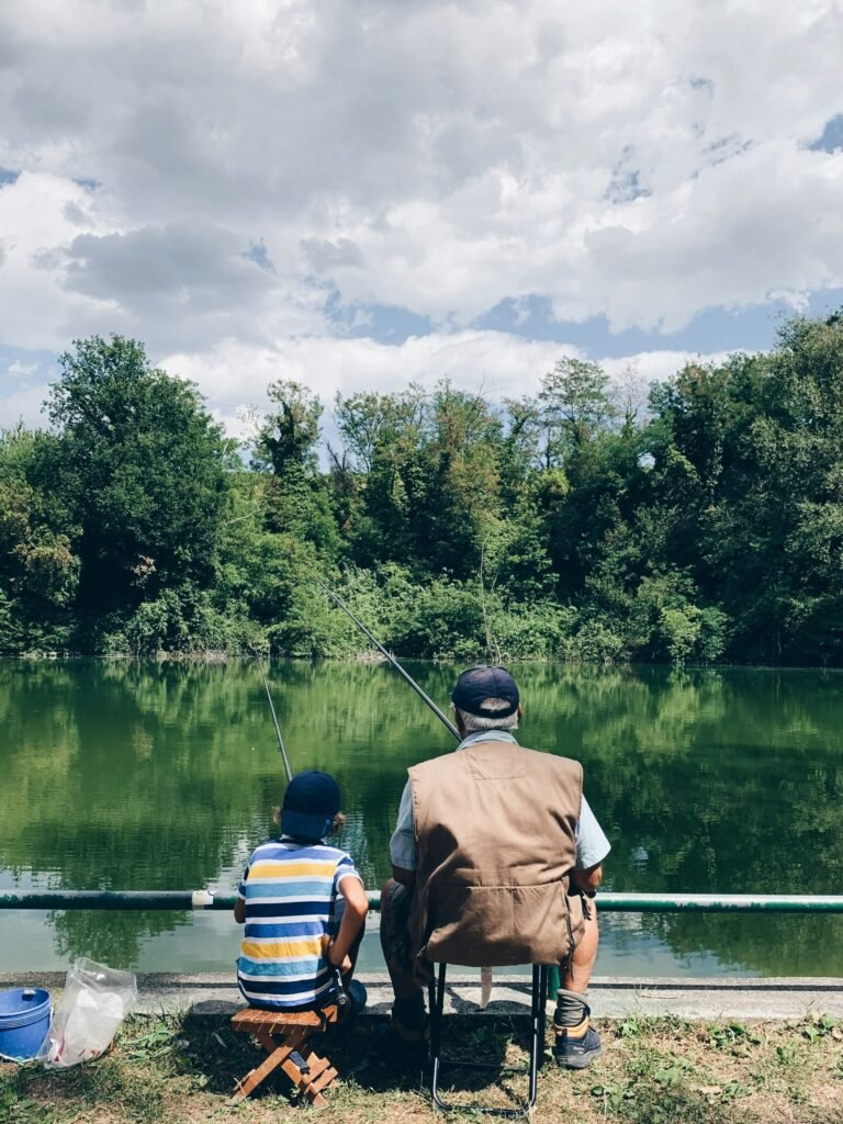 Grandfather and grandson fishing together.