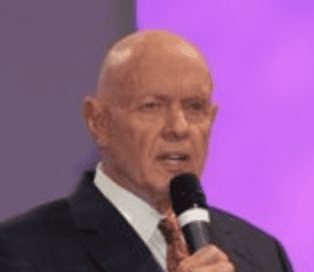 Man speaking into a microphone.