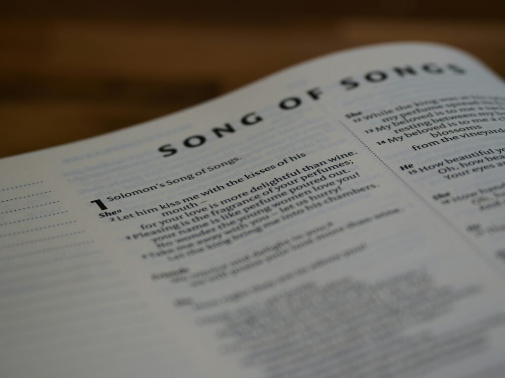 Open book with Song of Songs text.