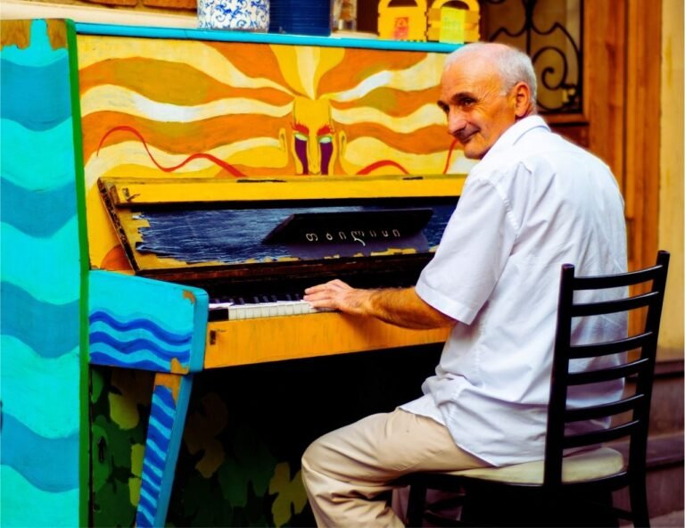 Man playing colorful street piano.