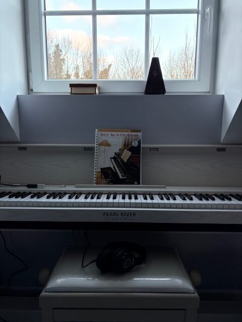 Piano at a light window