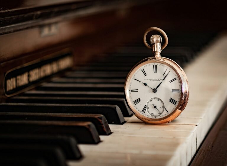 Vintage pocket watch on piano keys